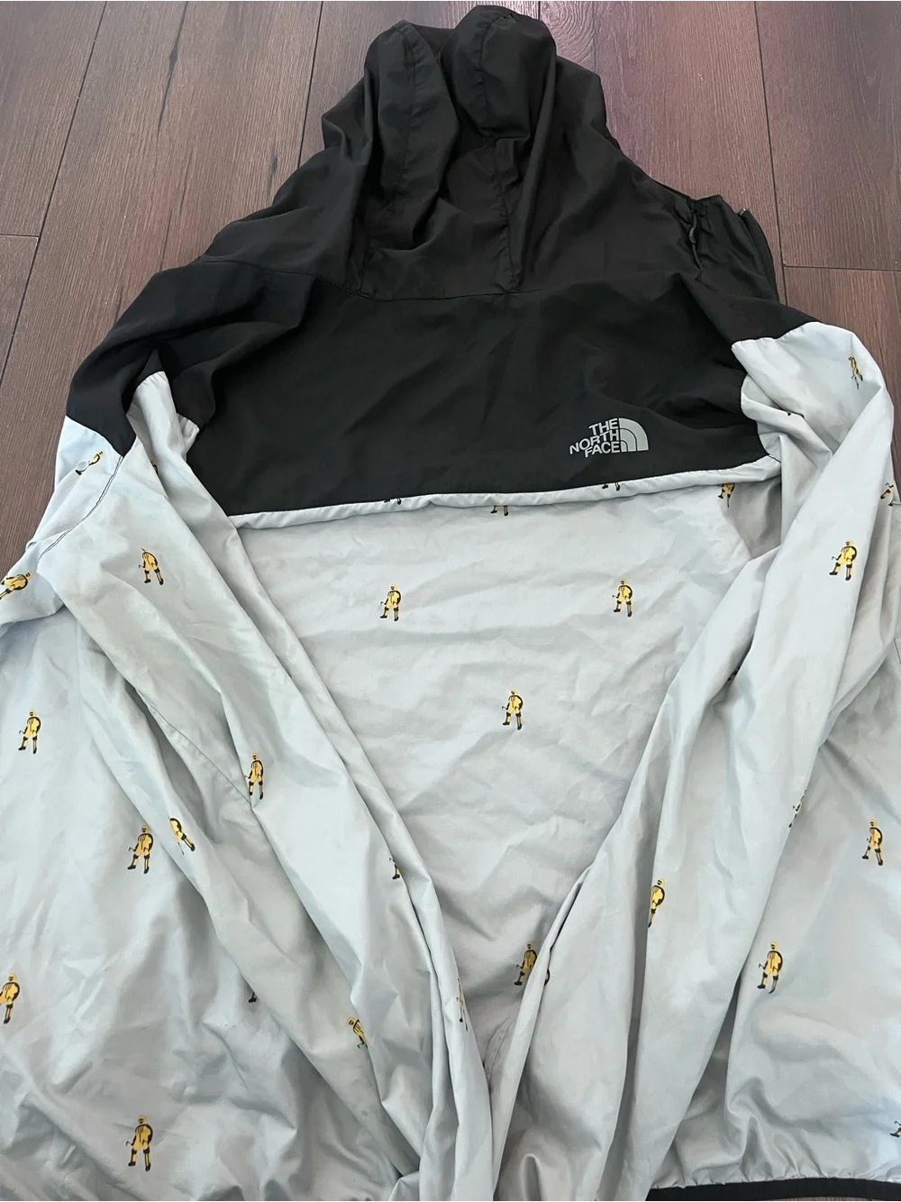 The North Face Black & Light Gray Hooded Windbreaker with Yellow Motif
